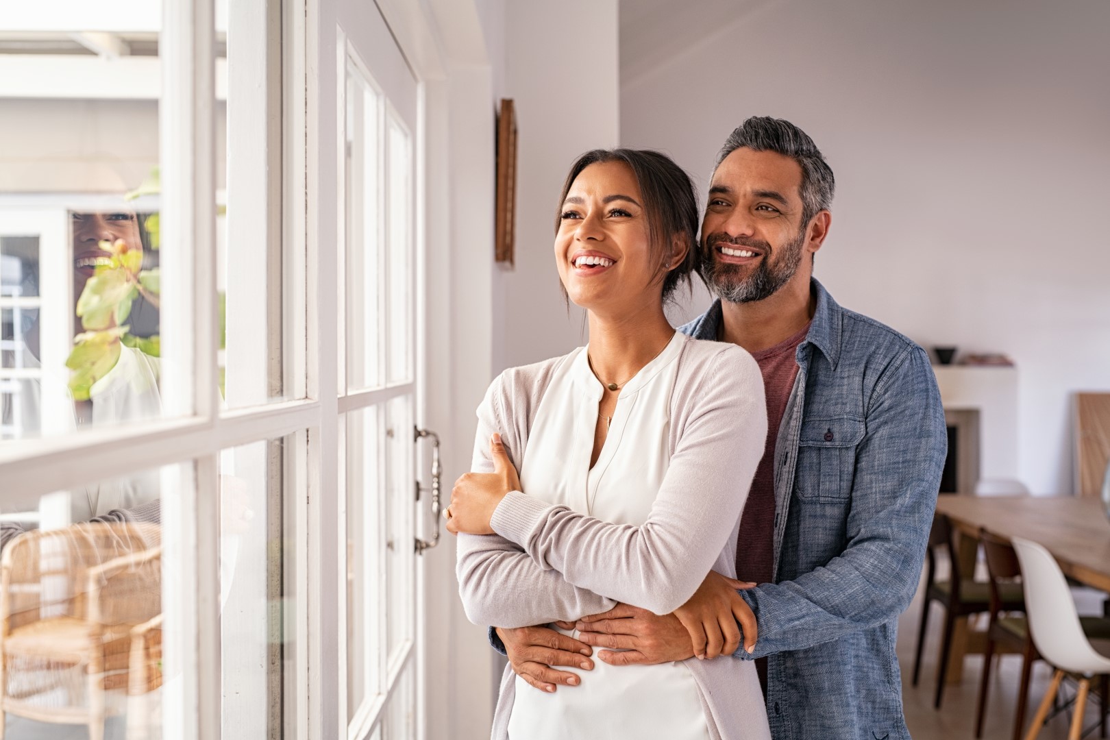Mature multiethnic couple thinking about their new home